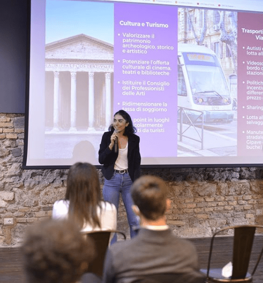 A group of people standing in front of a screen

Description automatically generated